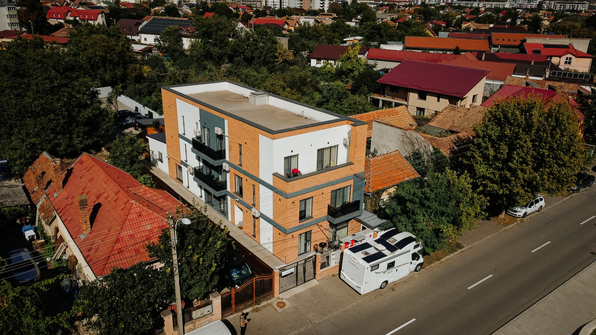 Riverside ApartHotel, a modern brick building among Cluj rooftops