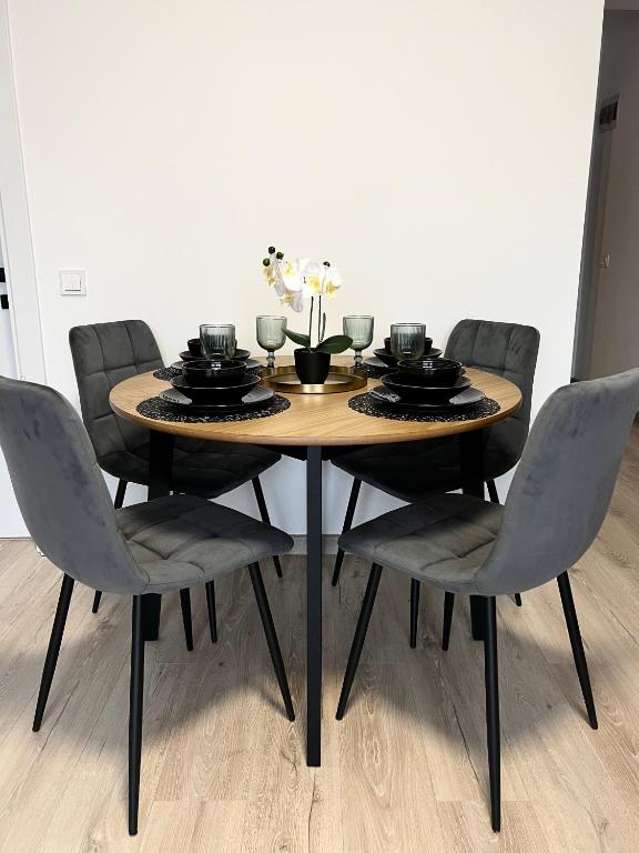A dining nook with an oak table set for a meal