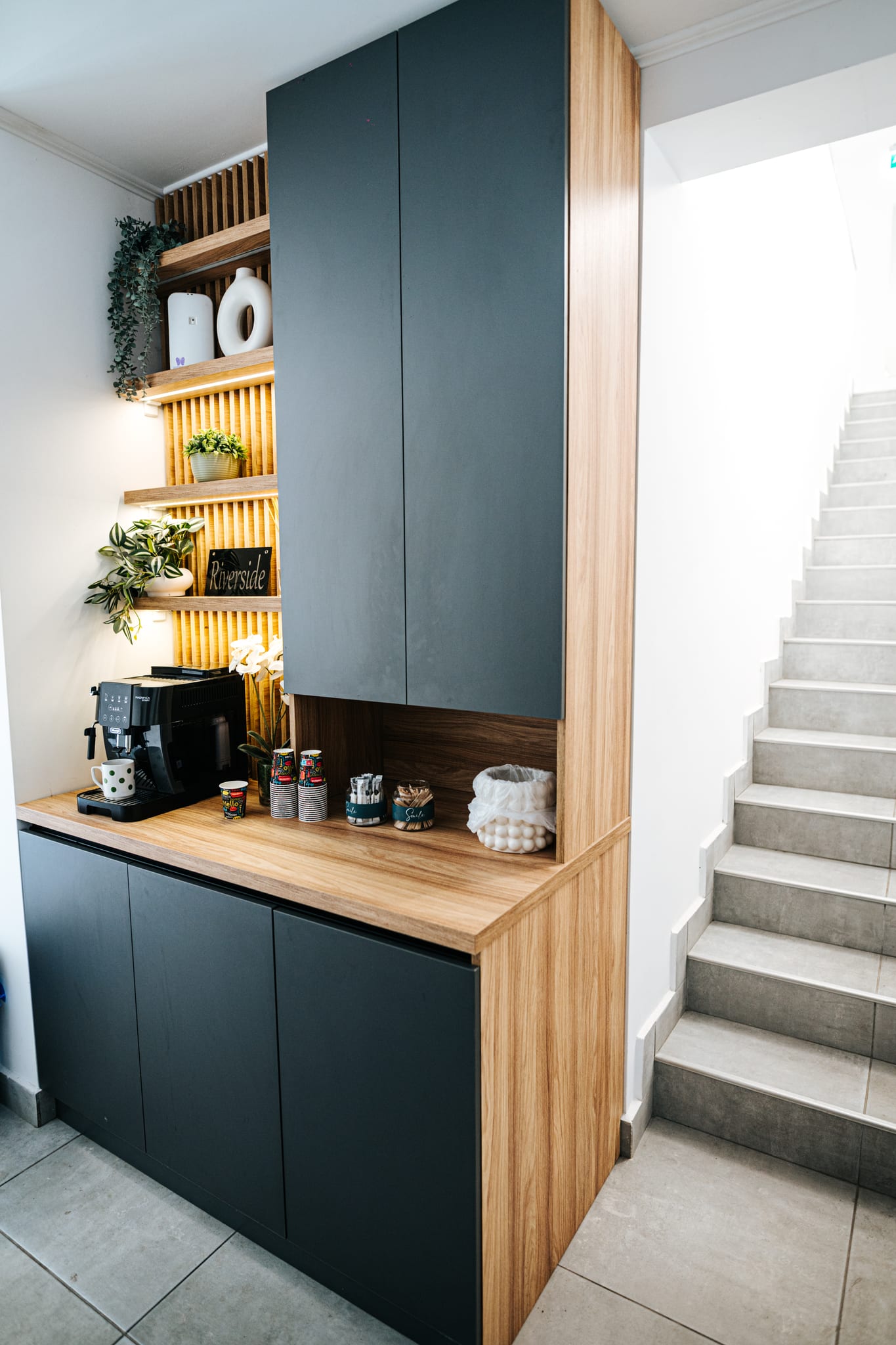 Warm oak reception nook with a coffee station